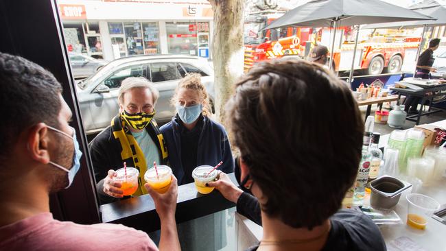 El Mahdi Amili, left, owner of Richmond bar and restaurant Macelleria, and bartender Jack Davis serving cocktails to locals Peter Swiatkiwsky and Jenny Robinson on Sunday. Picture: Paul Jeffers