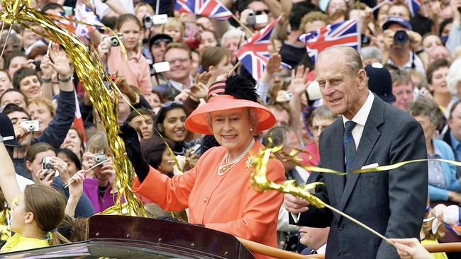 Queen Elizabeth II and Prince Phillip ride along the Mall in an open top car on their way to watch a parade in celebration of the Golden Jubilee in 2002. Picture: Getty Images.