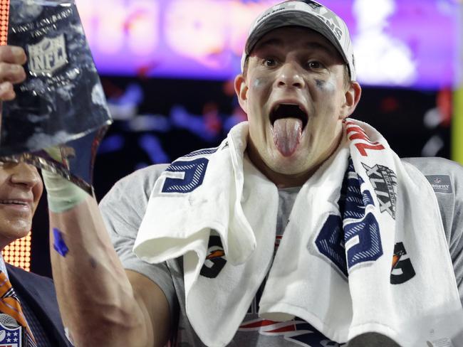 New England Patriots tight end Rob Gronkowski, left, and quarterback Tom Brady celebrate with the Vince Lombardi Trophy after the NFL Super Bowl XLIX football game against the Seattle Seahawks Sunday, Feb. 1, 2015, in Glendale, Ariz. The Patriots won 28-24. (AP Photo/Michael Conroy)