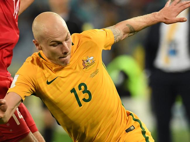 Australia's Aaron Mooy is tackled by Syria's Tamer Hag Mohamad during the 2018 World Cup qualifying football match between Australia and Syria at Stadium Australia in Sydney, Tuesday, October 10, 2017.(AAP Image/Dean Lewins) NO ARCHIVING, EDITORIAL USE ONLY