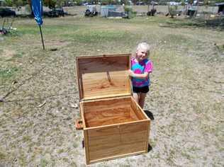 RAFFLE WINNER: Zo Edgley with her new camphor laurel blanket box. Picture: Mitchell Men's Shed