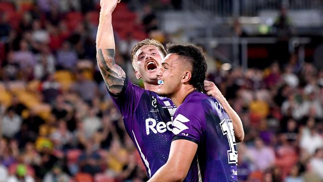 BRISBANE, AUSTRALIA - OCTOBER 16: Cameron Munster of the Storm celebrates victory with team mate Tino Faasuamaleaui after the NRL Preliminary Final match between the Melbourne Storm and the Canberra Raiders at Suncorp Stadium on October 16, 2020 in Brisbane, Australia. (Photo by Bradley Kanaris/Getty Images)