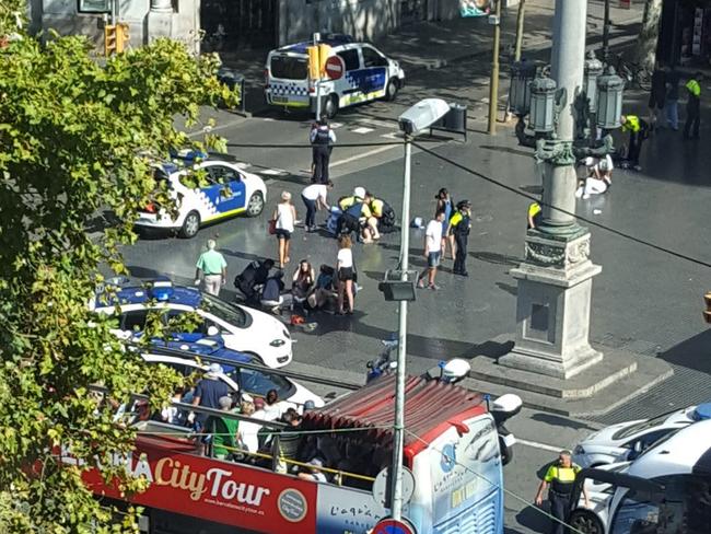 Injured are helped by responders. According to witnesses the white van swerved from side to side as it drove into tourists and residents. Picture: AP