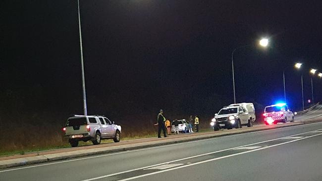 Police divert traffic to the old Bruce Highway after a car crashed in the southbound lane of the Bruce Highway near Kybong on Thursday night. Photos: Frances Klein