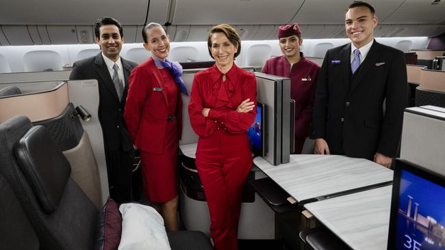 BRISBANE, AUSTRALIA - DECEMBER 04: In this image released on December 12, Jayne Hrdlicka, CEO of Virgin Australia, joins crew from both Virgin Australia and Qatar Airways onboard a Qatar Airways Boeing 777 at Brisbane Airport on December 04, 2024 in Brisbane, Australia. A new partnership between the two airlines has been launched which will deliver more value and choice to Australians, providing opportunities to travel to over 100 destinations across Europe, the Middle East and Africa. From December 12, Aussies can book Virgin Australia's new direct services from Sydney, Brisbane and Perth to Doha for travel from June 2025, with Melbourne set to launch later in 2025. These flights will be operated by Virgin Australia using Qatar Airways' spacious Boeing 777s, renowned for their Qsuite Business Class. (Photo by James D. Morgan/Getty Images for Virgin Australia)