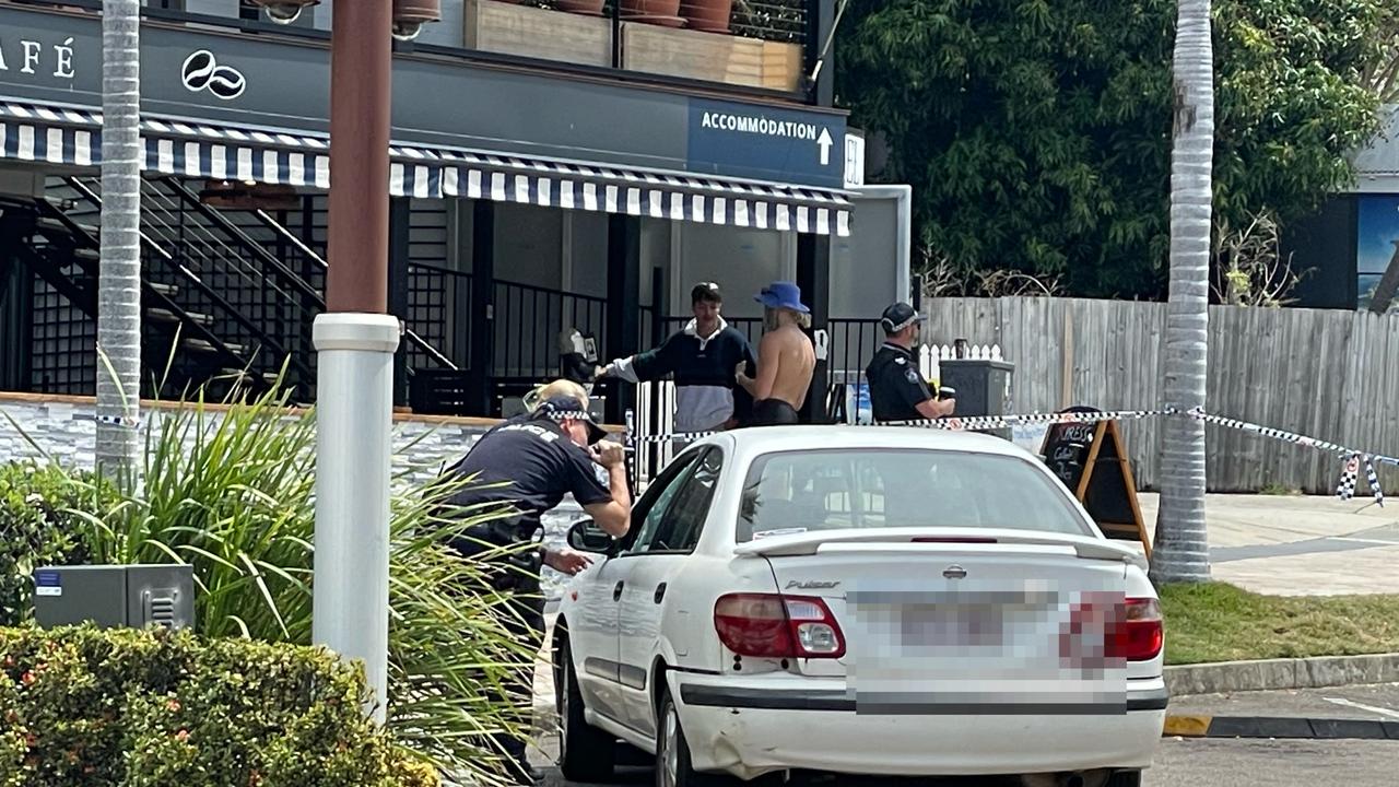 Police inspecting a vehicle hit with bullets when police were forced to shoot at a man charged at them armed with a knife. Picture: Janessa Ekert