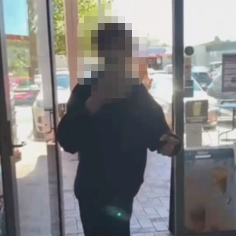 A still from a video of a teenager racially abusing cafe workers in the ACT by labelling them 'viruses'.