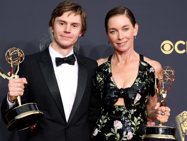 Evan Peters and Julianne Nicholson with their Emmys. Picture: AFP