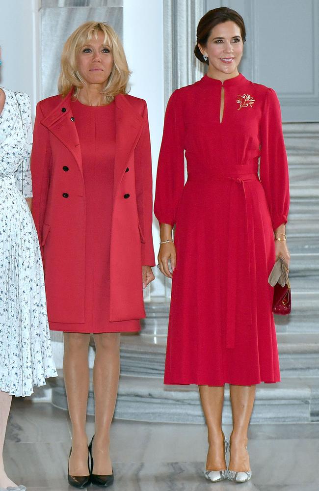 Ladies in red! Princess Mary, right, with French first lady Brigitte Macron. Picture: AFP 