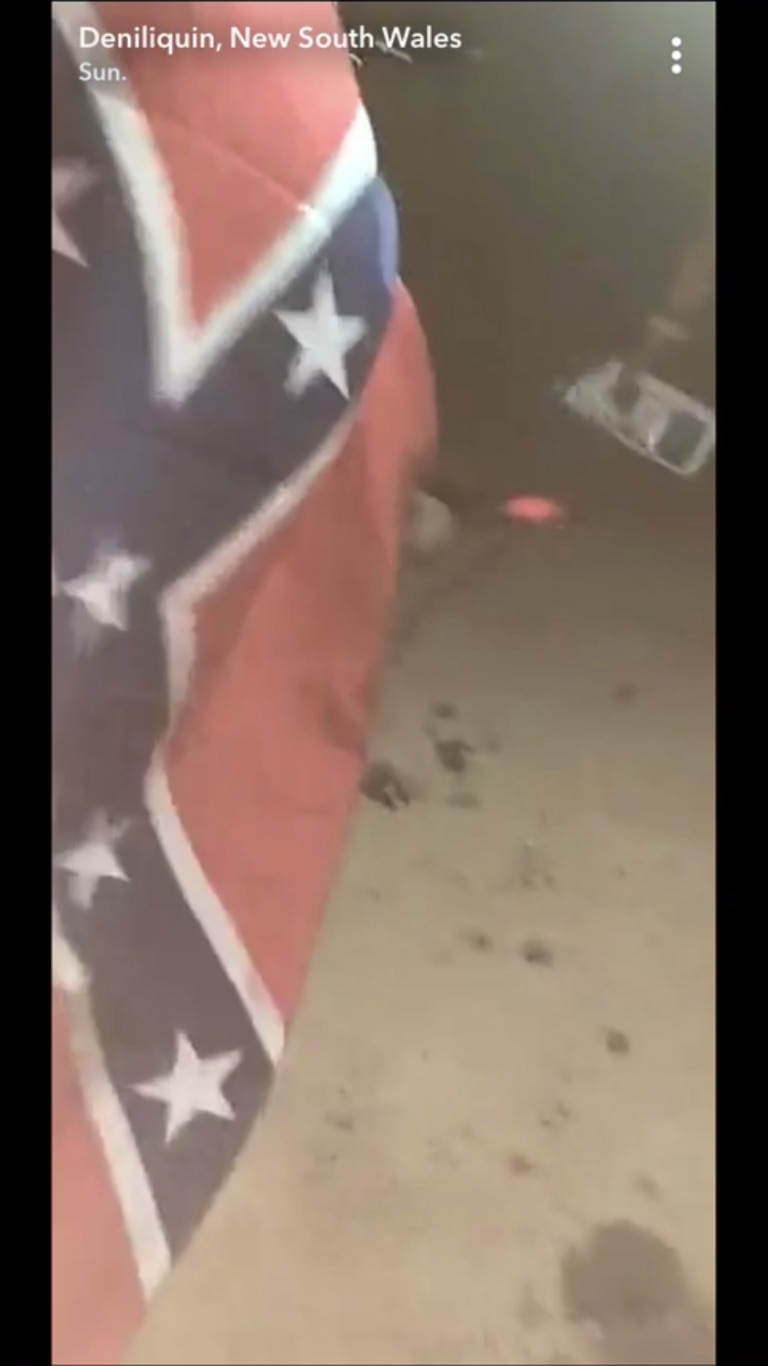 A man works with hot metal while draped in a Confederate flag at the Ute Muster. Picture: Snapchat