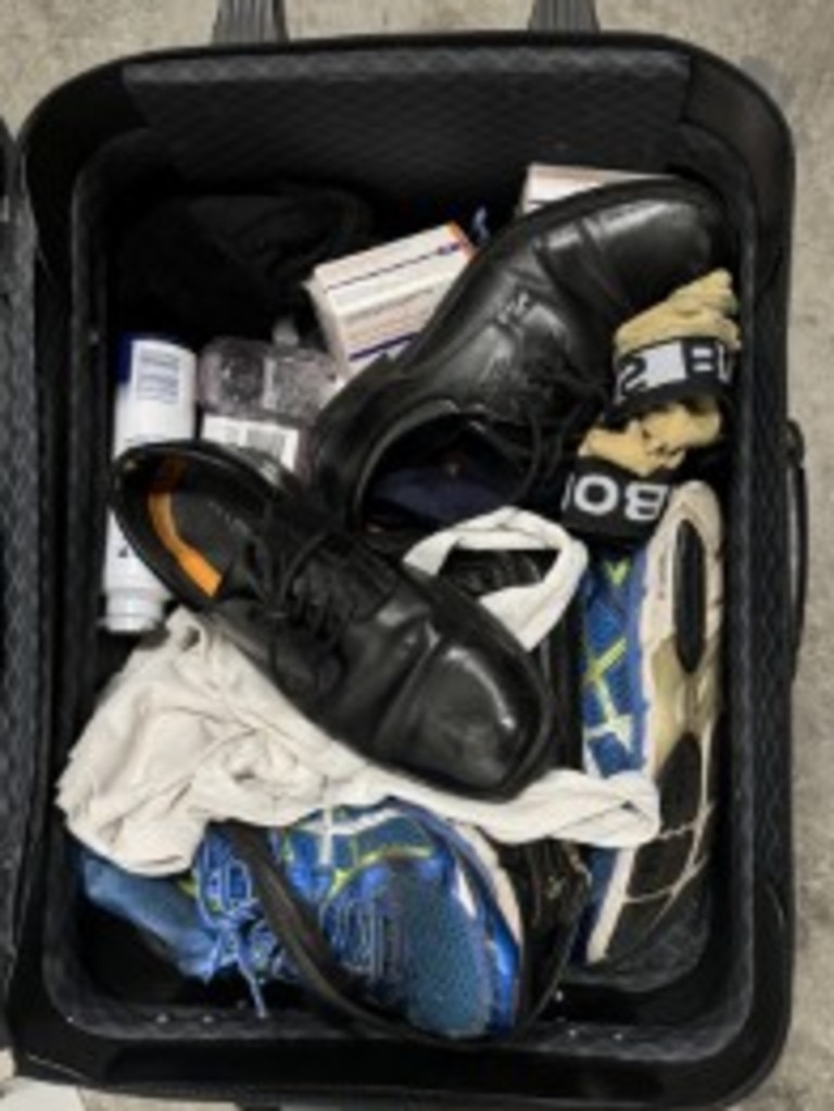 A black carry on suitcase filled with a man's clothes and shoes left behind in a 13cabs taxi. Picture: Supplied