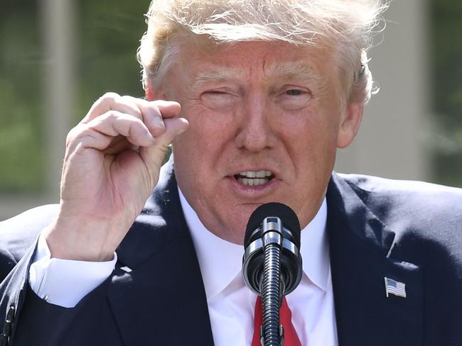 US President Donald Trump announces his decision to withdraw the US from the Paris Climate Accords in the Rose Garden of the White House in Washington, DC, on June 1, 2017.      "As of today, the United States will cease all implementation of the non-binding Paris accord and the draconian financial and economic burdens the agreement imposes on our country," Trump said. / AFP PHOTO / SAUL LOEB