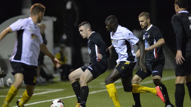 Mitch Mallia shields the ball against Moreton Bay United