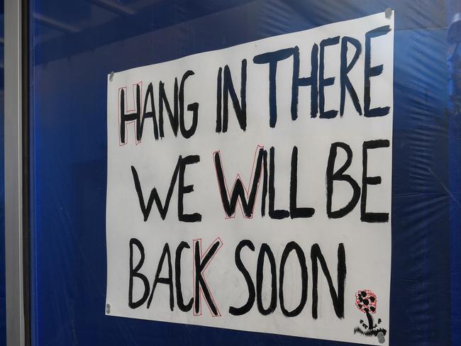 SIGN ON ONE OF THE DAMAGED SHOPS. Paul and Hayley Fyfield are the Bakers Delight  franchisees on Hampton st Hampton. Their shop along with others was gutted by fire after due to an electrical fault. They're very much looking forward to re-opening. PICTURE : PENNY STEPHENS. MONDAY 24TH AUGUST 2020