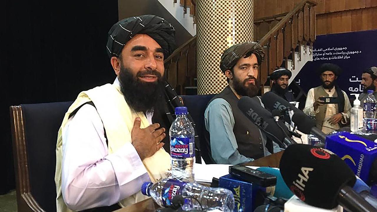 Taliban spokesperson Zabihullah Mujahid (L) gestures as he arrives to hold the first press conference in Kabul on August 17 following the Taliban’s stunning takeover of Afghanistan. Picture: Hoshang Hashimi/AFP