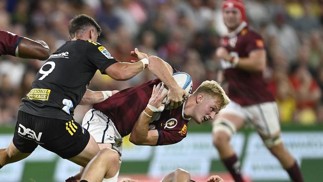 Reds flyhalf Tom Lynagh is tackled during his Super Rugby Pacific debut. Picture: Ian Hitchcock/Getty Images