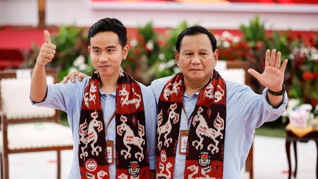 Prabowo Subianto, right, and Gibran Rakabuming Raka arrive to register at the election commission headquarters in Jakarta on Wednesday. Picture: Reuters