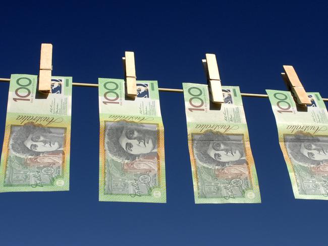 Four Australian $100.00 notes hanging on the line; Australian dollars on clothes line with peg, generic cash