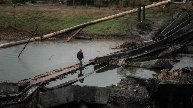 A man crosses a destroyed bridge in the frontline town of Bakhmut in the Donetsk region of Ukraine.