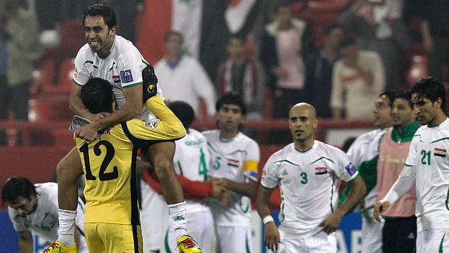 Iraq celebrate qualifying for the second phase.