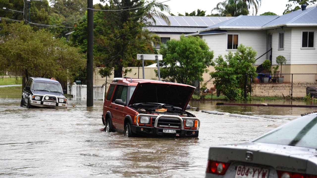 Cars stuck in flood waters on Baratta St, Southport. Picture: Steven Holland