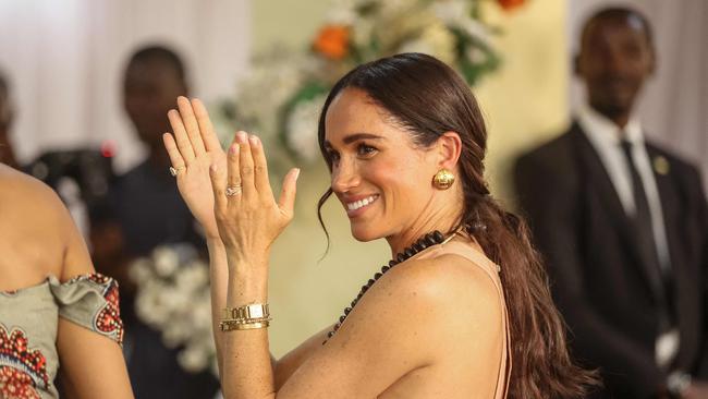 Britain's Meghan, Duchess of Sussex, gestures as she arrives with Britain's Prince Harry (unseen), Duke of Sussex, during their visit at the Lightway Academy in Abuja on May 10, 2024 as they visit Nigeria as part of celebrations of Invictus Games anniversary. (Photo by Kola SULAIMON / AFP)