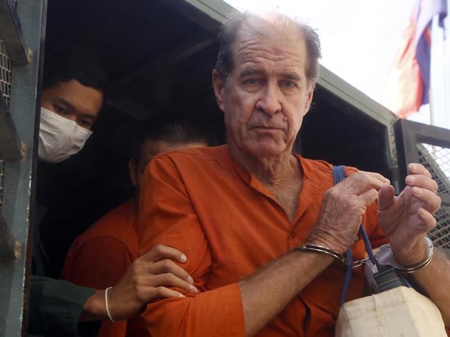 James Ricketson is helped from a prison truck upon his arrival at court in Phnom Penh. Picture: AP