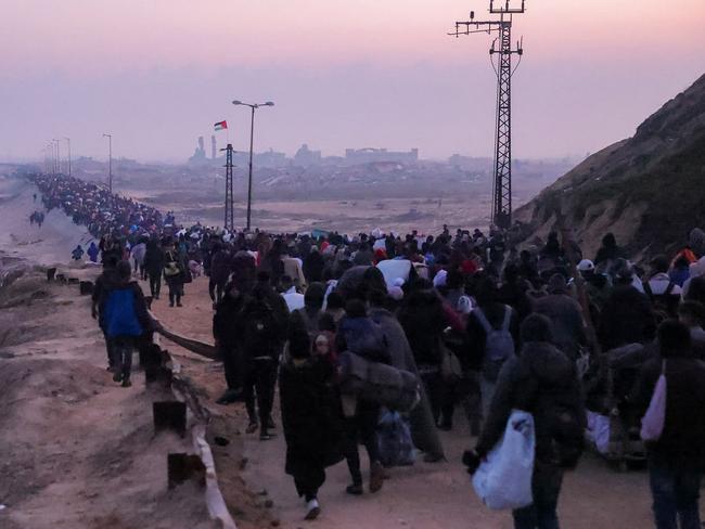 People walk along Gaza's coastal al-Rashid Street in Nuseirat towards the Netzarim corridor to cross to the northern part of the Gaza Strip. Picture: AFP