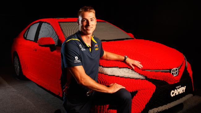 Daniel Talia with a life-size Toyota Camry made out of Lego at the Brickman Awesome Lego Exhibition. Toyota has just extended its sponsorship of the Crows for another four years. Picture Matt Turner