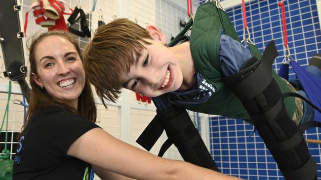 Angus Hopkins, from Nobby working with Belinda Bell from Toowoomba Kids Physiotherapy. In 2019, Angus finally received a wheelchair through NDIS after months of haggling, his wheelcair finally was supplied thanks to stories in The Chronicle. Twelve months on, Angus is mobile and able to to take part in a variety of activities. Photo Bev Lacey