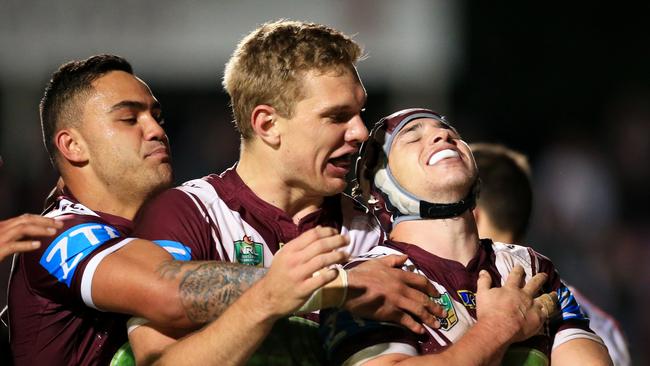 Tom Trbojevic celebrates with Manly teammates Dylan Walker and Jamie Buhrer.