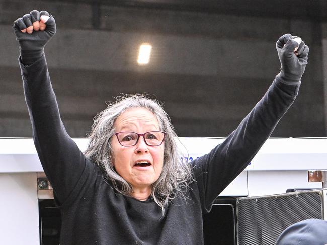 Extinction rebellion protester Meme Thorne was arrested after disrupting Adelaide traffic by abseiling from the Morphett Street Bridge. Picture: NCA NewsWire/Brenton Edwards