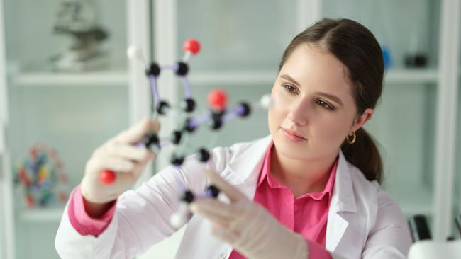 Scientist student holding a model of molecule in laboratory. Chemical and physical discoveries and study of science