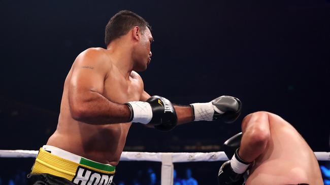 Justin Hodges lands the early blow against Troy McMahon. Picture: Getty