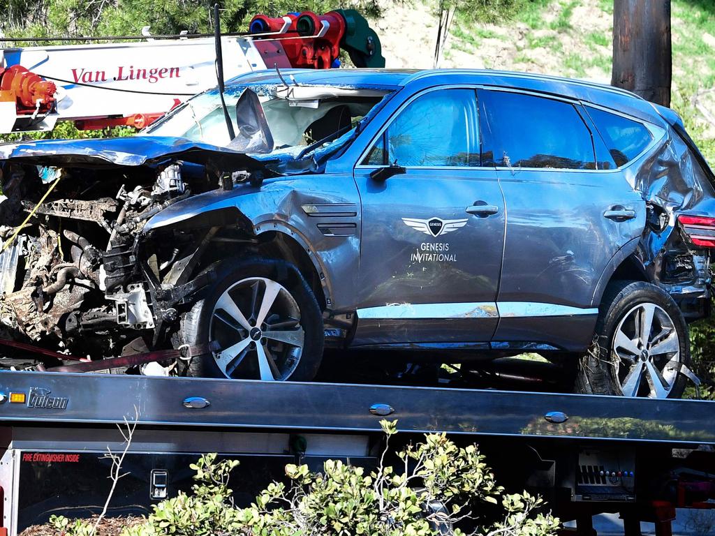 A tow truck recovers the car driven by golfer Tiger Woods in after a car accident in February. Picture: AFP