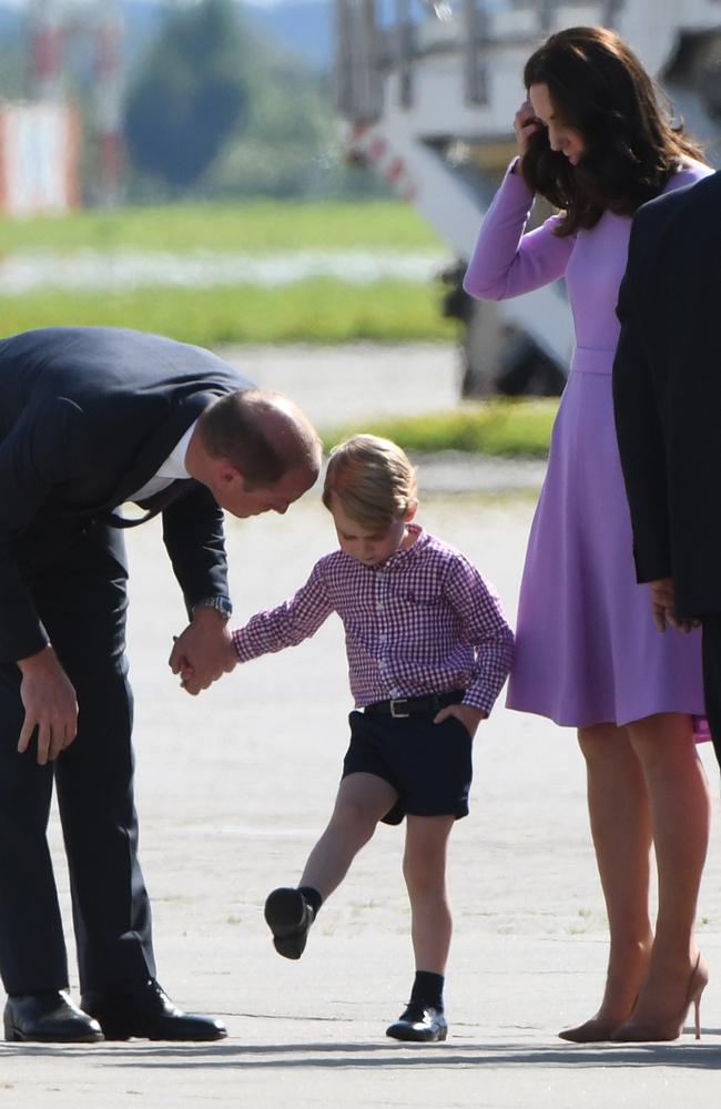 Britain's Prince William urges his son Prince George through the last stage of their three-day visit to Germany. Picture: AFP