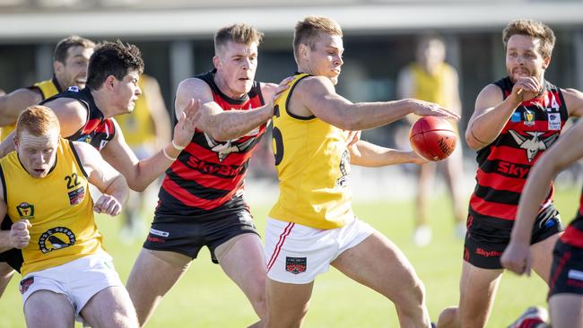 North Launceston’s Jay Foon gets his kick away under pressure from Lauderdale players. Picture: Eddie Safarik