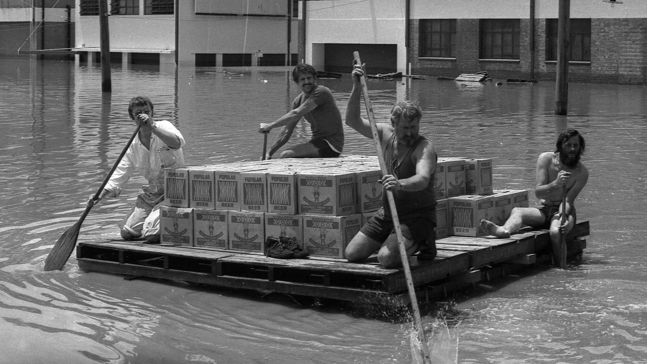 Beer being paddled to safety during the 1974 Brisbane floods, a defining moment for the city.