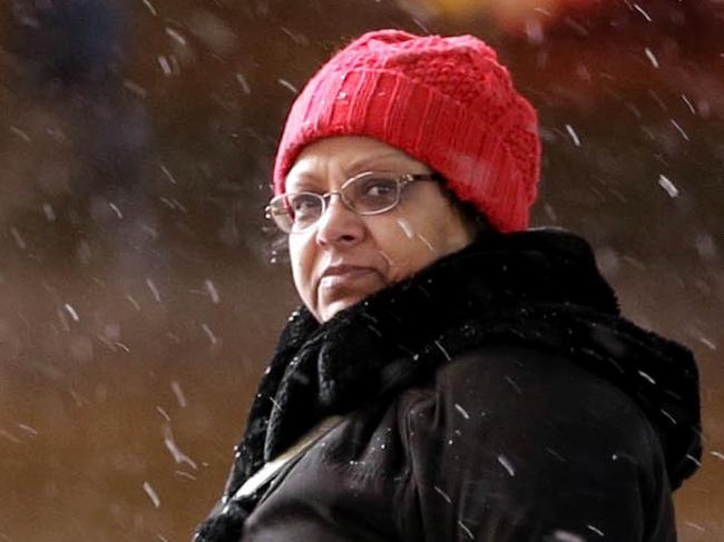 A woman crosses a mostly empty 42nd Street in Times Square, New York, Monday, Jan. 26, 2015. More than 35 million people along the Philadelphia-to-Boston corridor rushed to get home and settle in Monday as a fearsome storm swirled in with the potential for hurricane-force winds and 1 to 3 feet of snow that could paralyze the Northeast for days. (AP Photo/Seth Wenig)