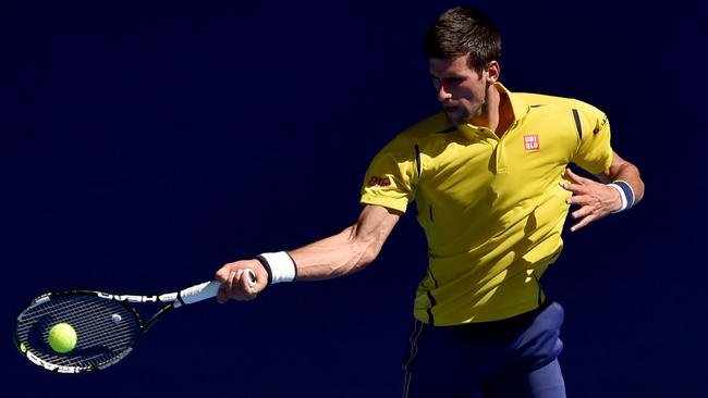 TOPSHOT - Serbia's Novak Djokovic plays a forehand return during his men's singles match against South Korea's Chung Hyeon on day one of the 2016 Australian Open tennis tournament in Melbourne on January 18, 2016. AFP PHOTO / SAEED KHAN-- IMAGE RESTRICTED TO EDITORIAL USE - STRICTLY NO COMMERCIAL USE / AFP / SAEED KHAN