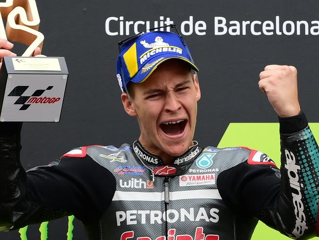 TOPSHOT - Petronas Yamaha SRT's French rider Fabio Quartararo celebrates on the podium after winning the MotoGP race of the Moto Grand Prix de Catalunya at the Circuit de Catalunya on September 27, 2020 in Montmelo on the outskirts of Barcelona. (Photo by LLUIS GENE / AFP)