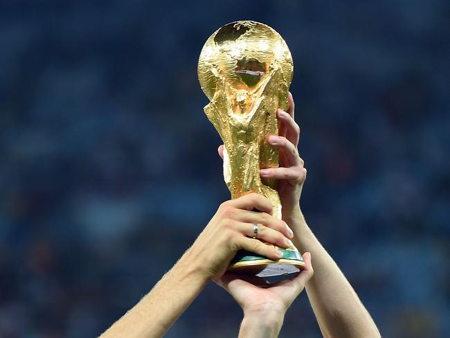 (FILES) In this file photo taken on July 13, 2014, Germany's forward Thomas Mueller (L) and Germany's midfielder Julian Draxler pose with the World Cup trophy after winning the 2014 FIFA World Cup final football match between Germany and Argentina 1-0 following extra-time at the Maracana Stadium in Rio de Janeiro, Brazil. Germany's national football team head coach Joachim Loew named the players of his extended 27-man pre-squad for the 2018 FIFA Football World Cup on May 15, 2018. / AFP PHOTO / Patrik STOLLARZ