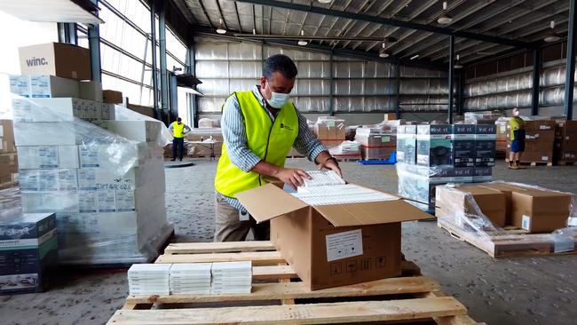 Workers were seen packing boxes of tests in pictures supplied by the Education Department. Picture: Supplied via NCA NewsWire