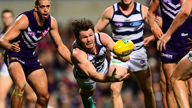 Patrick Dangerfield fires out a handball against Fremantle.