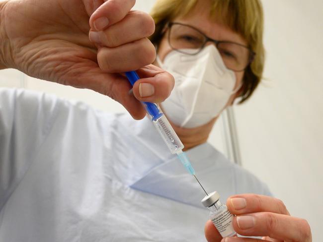 A medical assistent fills a syringe with a dose of COVID vaccine. Picture: AFP