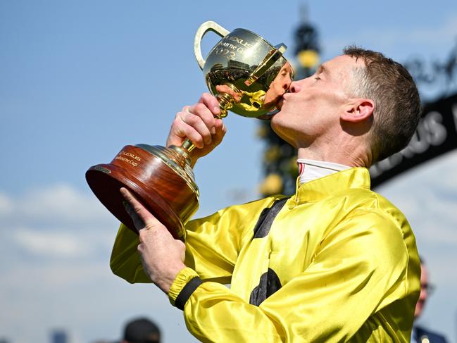 MELBOURNE, AUSTRALIA - NOVEMBER 07: Mark Zahra poses with trophy after riding Without A Fight to win Race 7, the Lexus Melbourne Cup,  during Melbourne Cup Day at Flemington Racecourse on November 07, 2023 in Melbourne, Australia. (Photo by Vince Caligiuri/Getty Images)