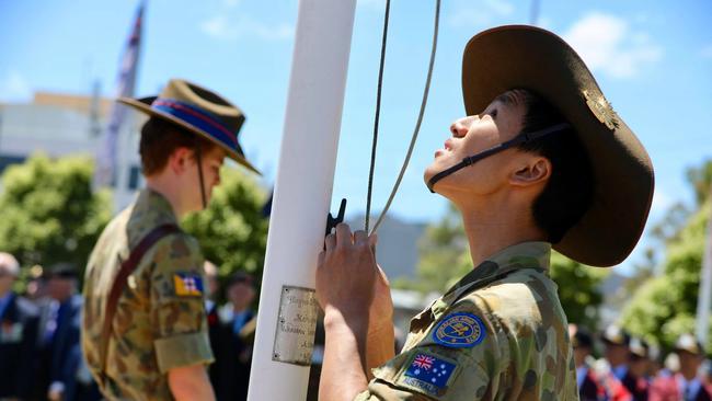 A member of the Catafalque Party raises the flag at Cenotaph Park. Picture: Nicholas Ryan