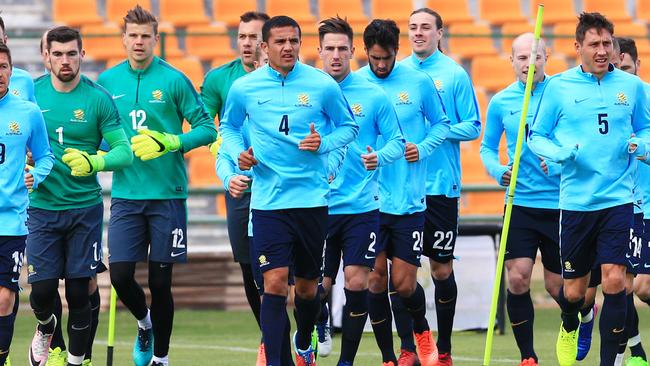 The Socceroos warm up during a training session.