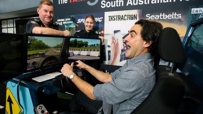 Superintendent Bob Gray, Senior Sergeant Susan O'Connor and David Penberthy, who is sitting in the South Australian Police driving simulator. Picture: Morgan Sette