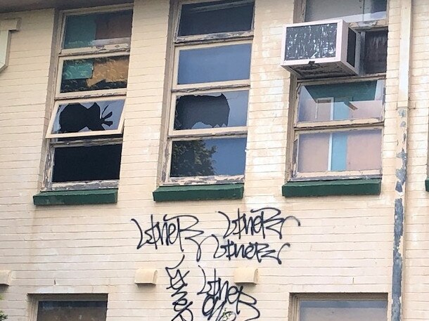 Smashed windows and graffiti at McLeod House on Monday. It has become a community eyesore at Allambie Heights. Picture: Jim O'Rourke